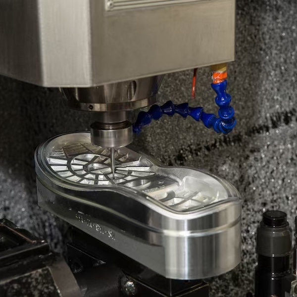 CNC machine cutting outsole mold with coolant